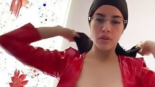 sexy Arab in leather dress doing voluptuous dance with her hijab on